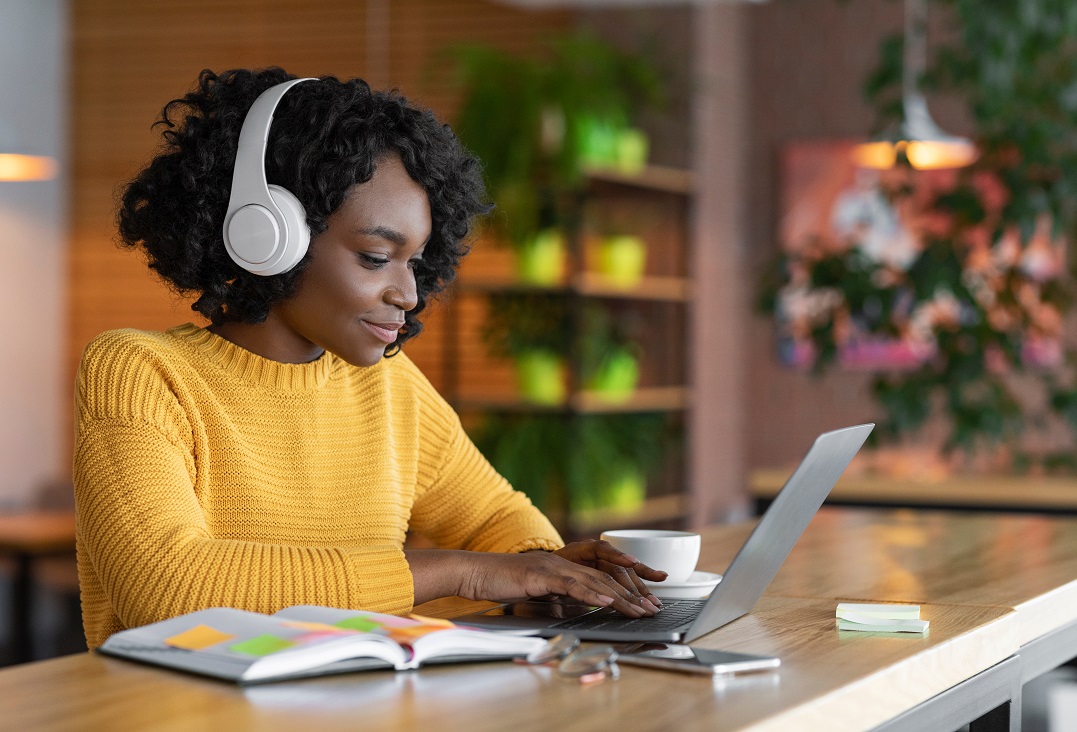 Young woman in front of her laptop learning the differences between you both or both of you