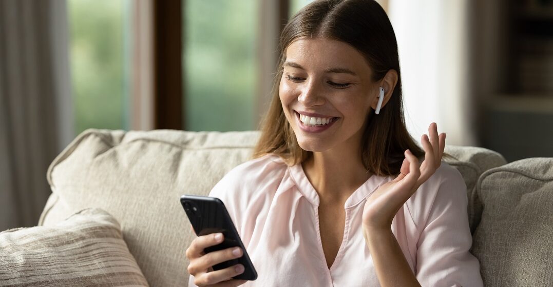 Una mujer toma una clase en línea sobre comparativos y superlativos en inglés en su teléfono
