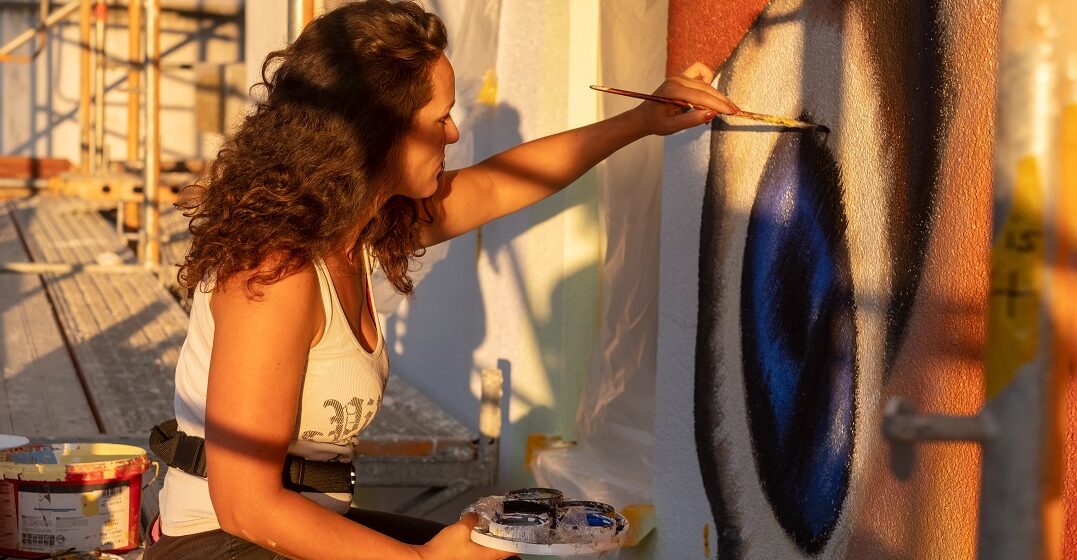 Young woman doing French street art
