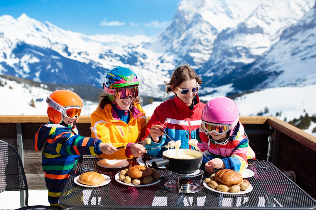 Family in Switzerland having Swiss food