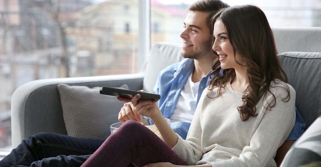Couple watching a talk show in French
