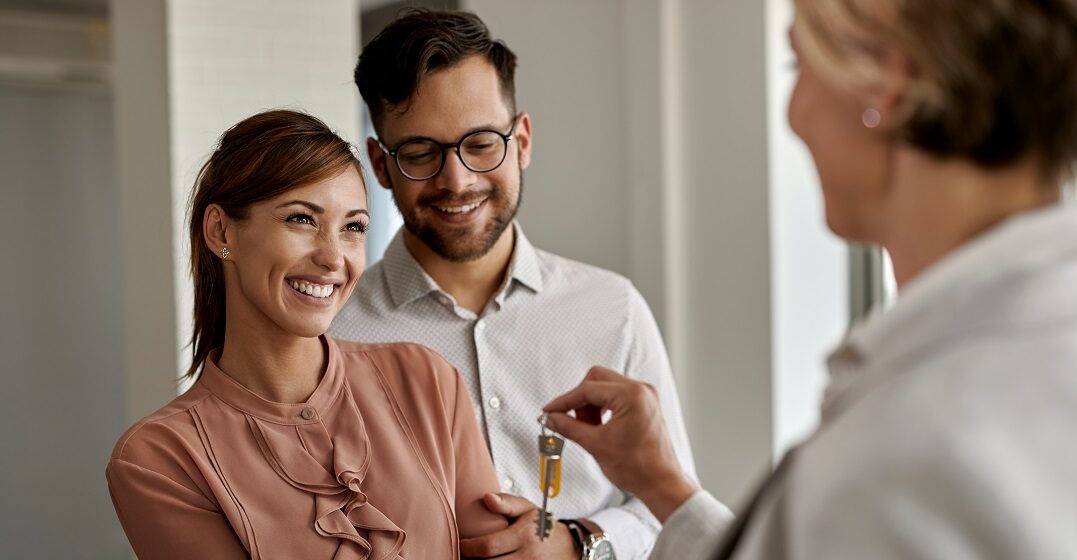 A couple receiving the key to their house they buy in Switzerland