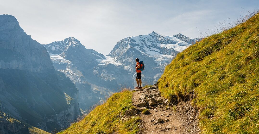 A hiker in the Swiss mountains as a representation of bank holidays in Switzerland