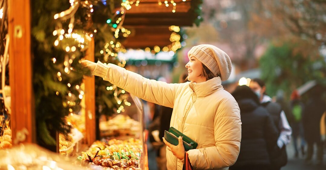 Young woman at a stall at a Christmas market in Switzerland