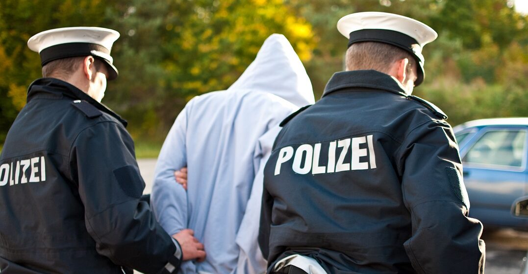 Police officers in Germany escorting a criminal who comitted a crime