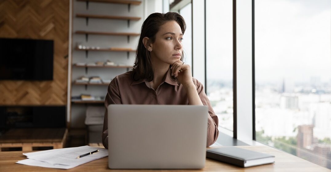 A businesswoman at her desk wondering German vs. French: What’s the best language to learn?