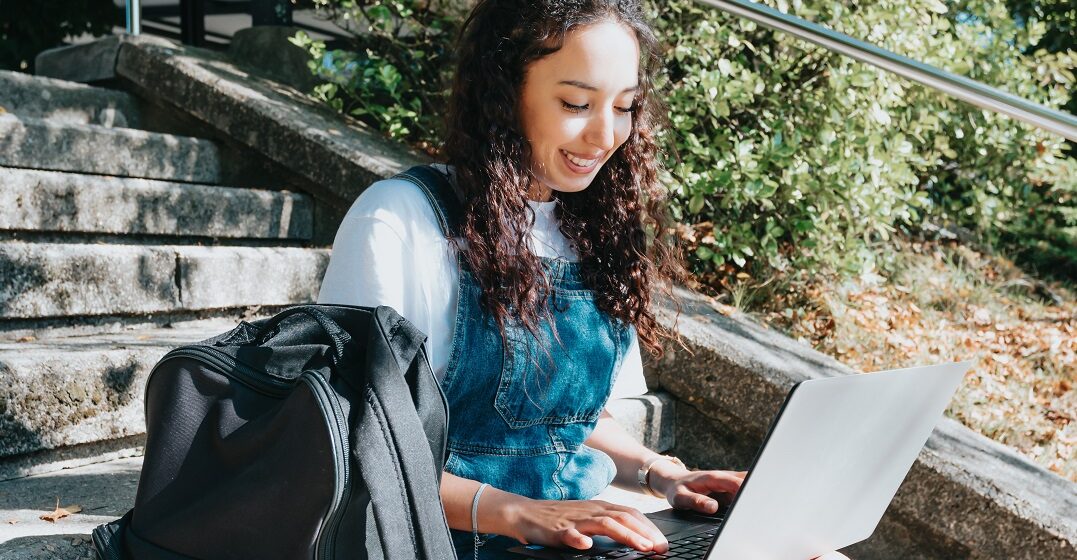 Female student at her laptop doing an MBA in Germany