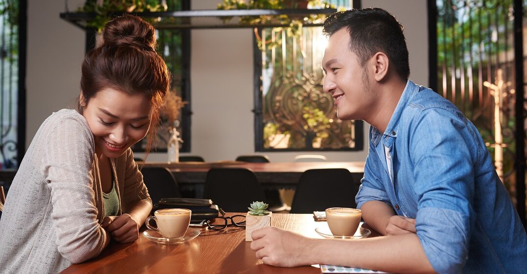 Side,View,Portrait,Of,Loving,Asian,Couple,Meeting,In,Cafe and giving each other a compliment is Spanish