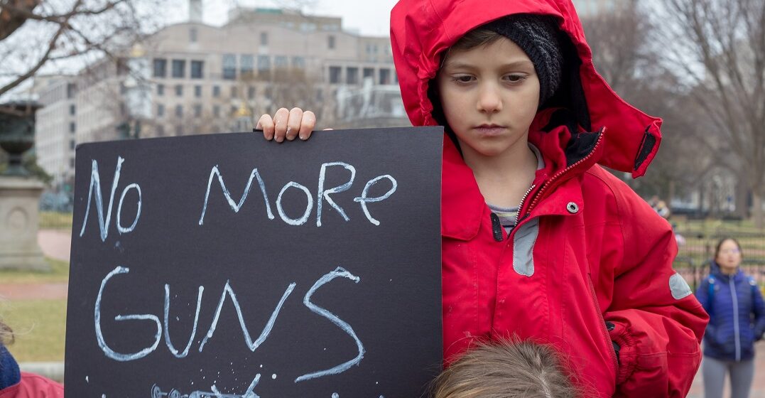 A boy holding up a sign 