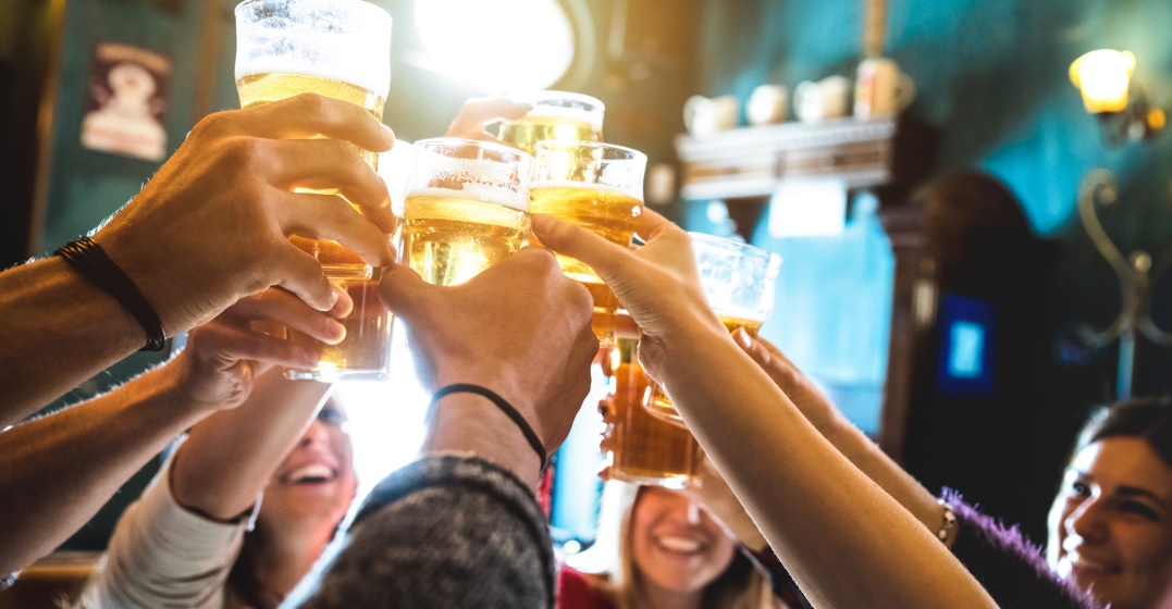 People clingin beer glasses and saying