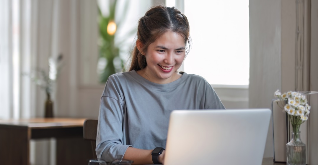 Blonde woman at her laptop learning about 
