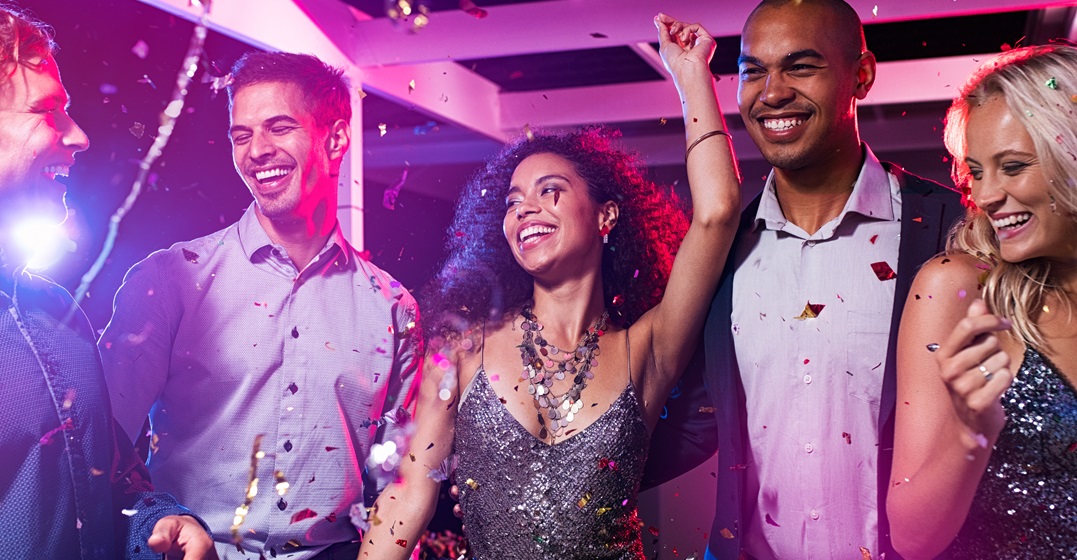 A group of friends dancing in a club to Spanglish pop songs