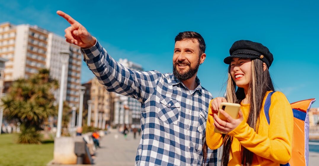White,Male,Giving,Direction,To,A,Young,Asian,Female,Tourist