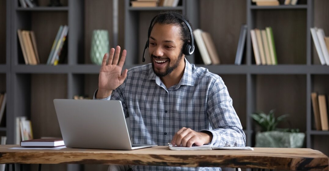 Friendly,Happy,African,Hipster,Guy,In,Headphones,With,Mic,Waving