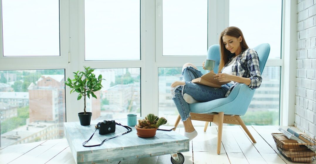 Young,Attractive,Woman,Read,Book,And,Drink,Coffee,Sitting,On