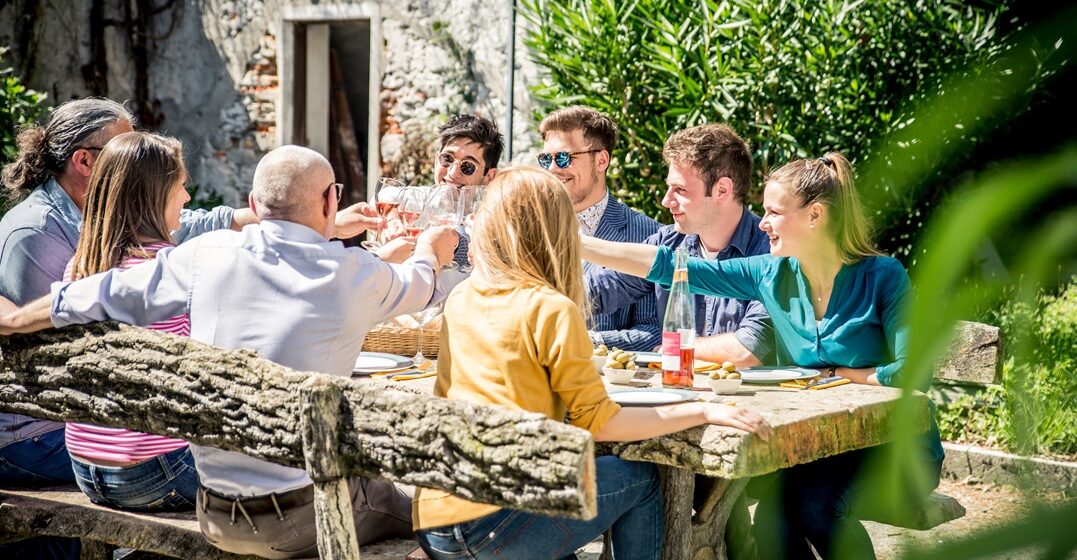 Group,Of,Friends,Eating,Outdoor.,Sitting,Outside,And,Enjoying,Food.