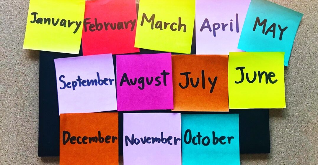 Monthly,Hand,Writing,On,Colorful,Note,On,Wooden,Board,Background,