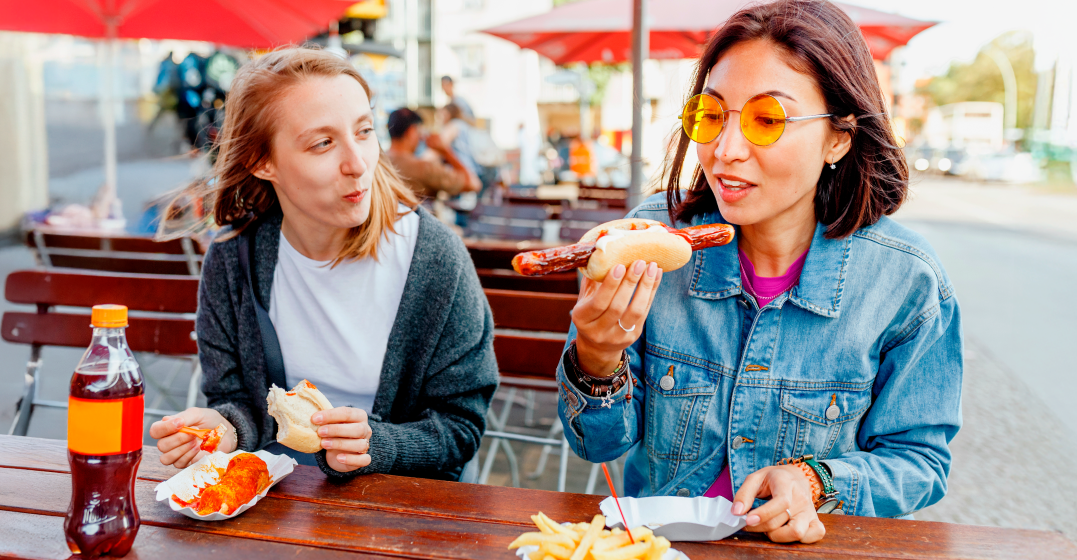 Two young women enjoying German food together