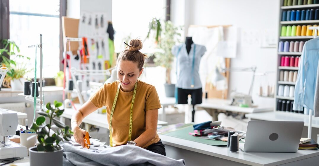 Tailor woman creating some new clothes in a French shop