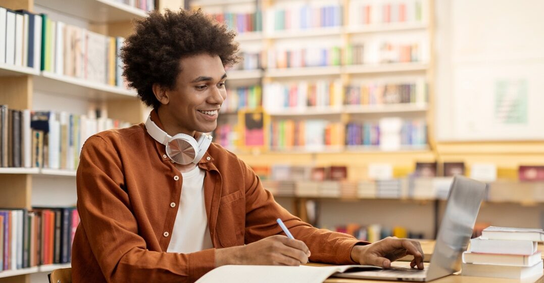 young man at his desk, learning how to use auxiliary verbs in German