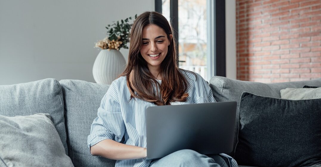 Millenial girl sitting on the sofa learning how to use wo wohin and woher in german