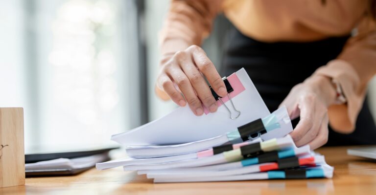 Woman sorting paperwork as part of German bureaucracy