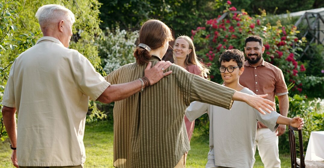 Multiculti family in their backyard welcoming in German