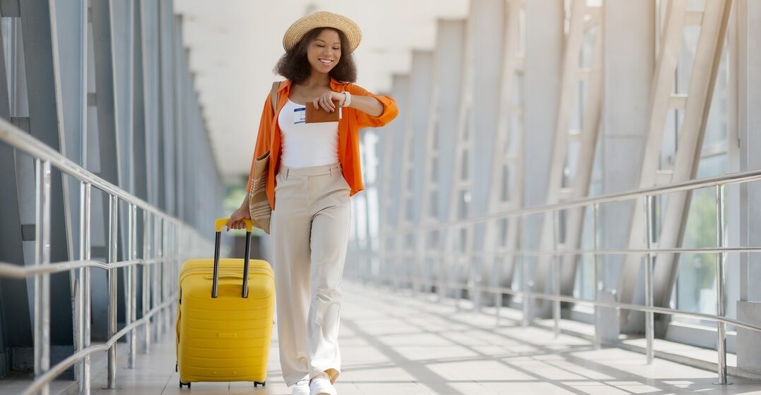 young woman checking the time and thinking about time prepositions while travelling