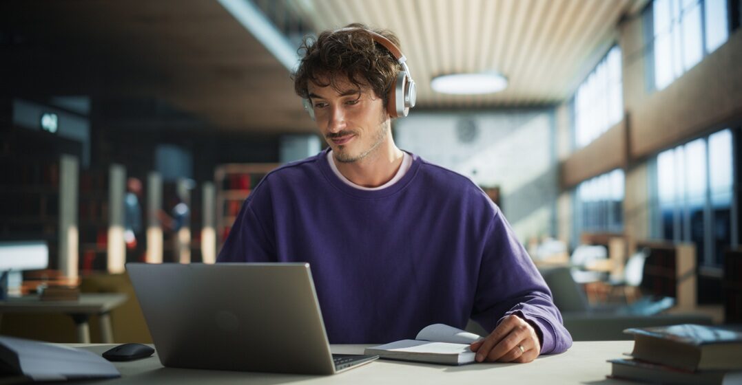 Young man at his desk, learning the meaning o ja in German