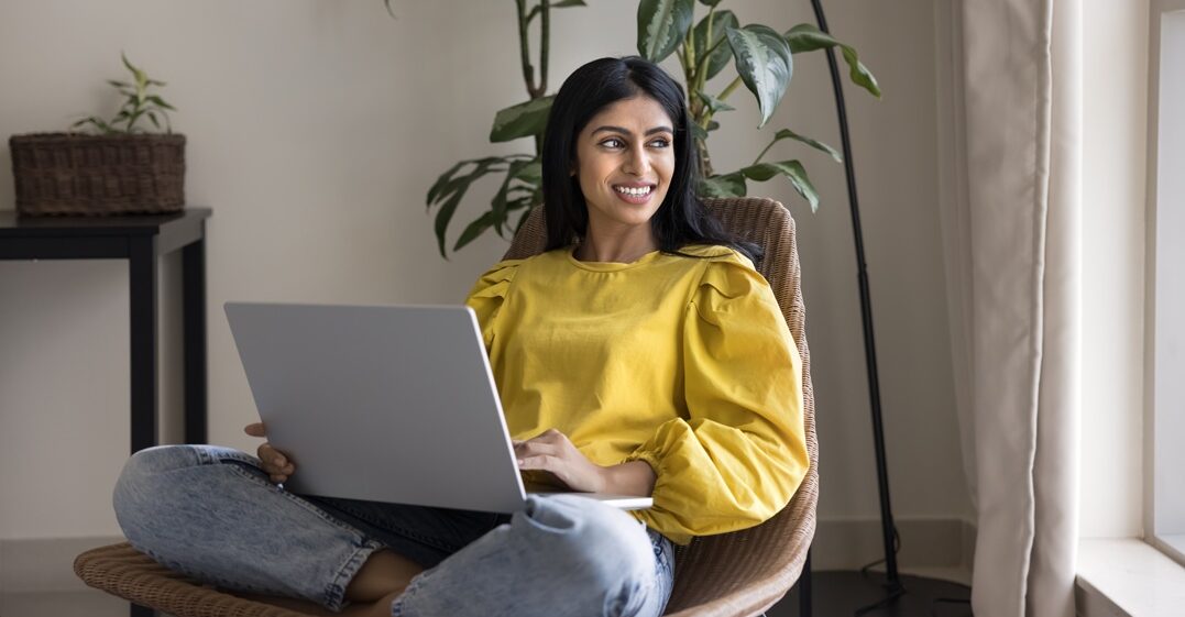 young woamn sitting on an armchair and pondering on the meaning of wie in german