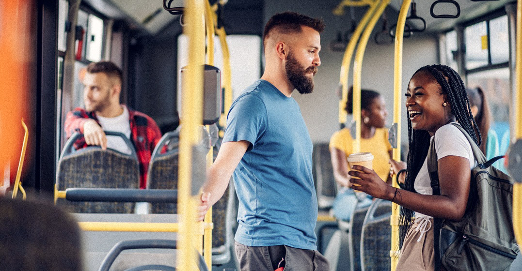 Young man and woman on a bus in Germany, talking about the German stare
